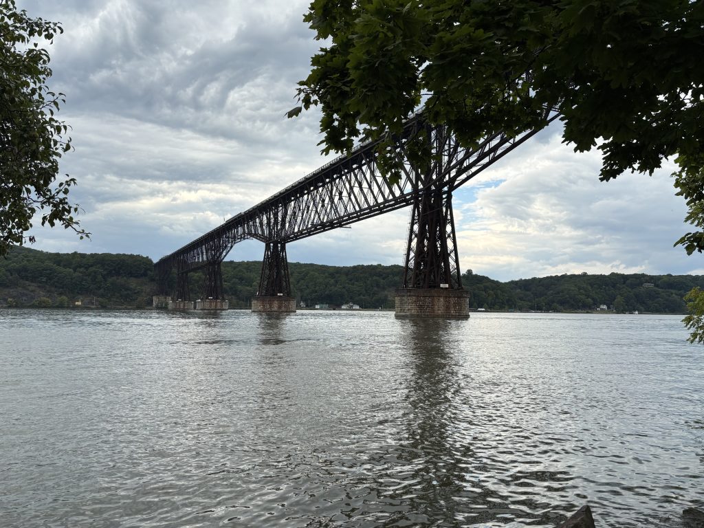 Photo looking up at a bridge.